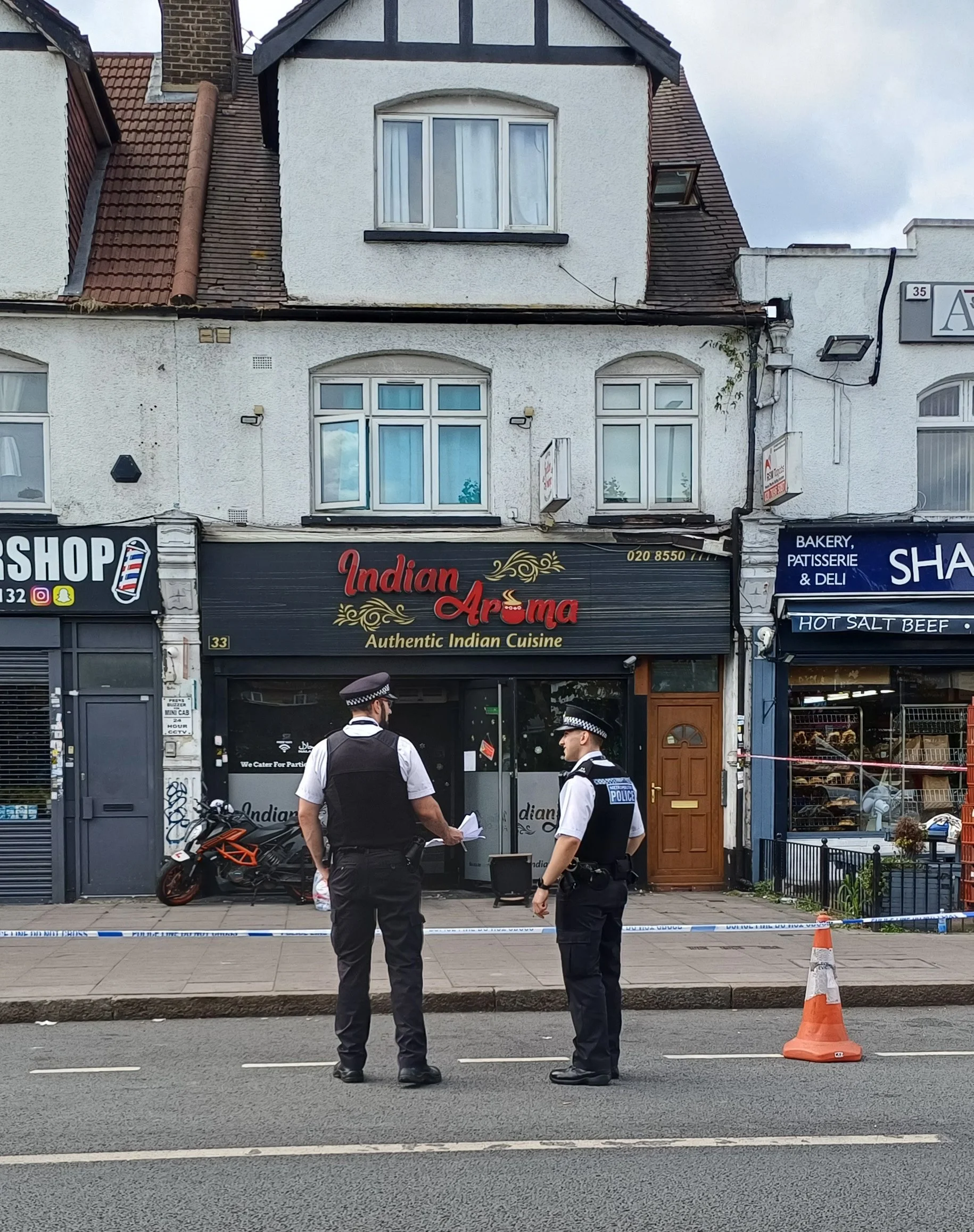 Police outside a restaurant following the arson incident.