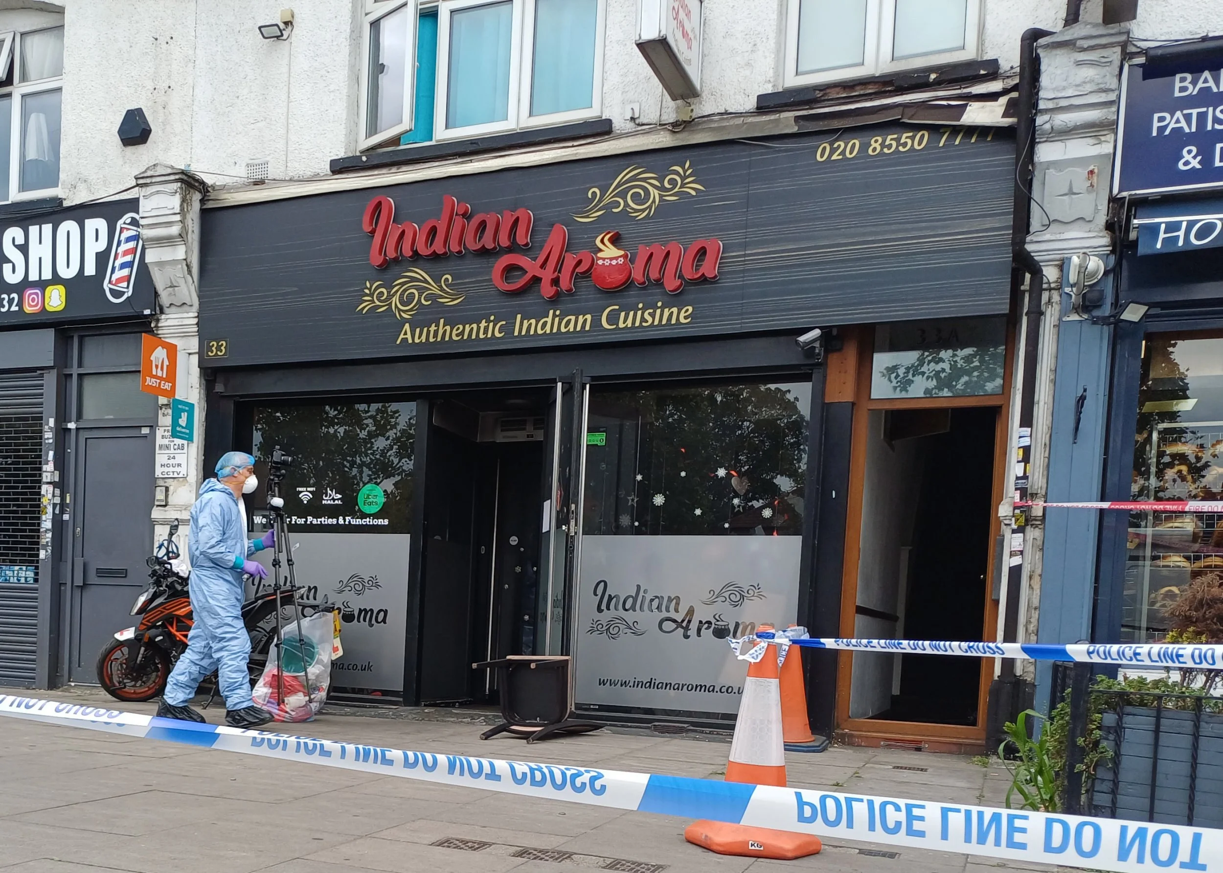 Forensic investigators at the restaurant in Ilford after the arson attack.