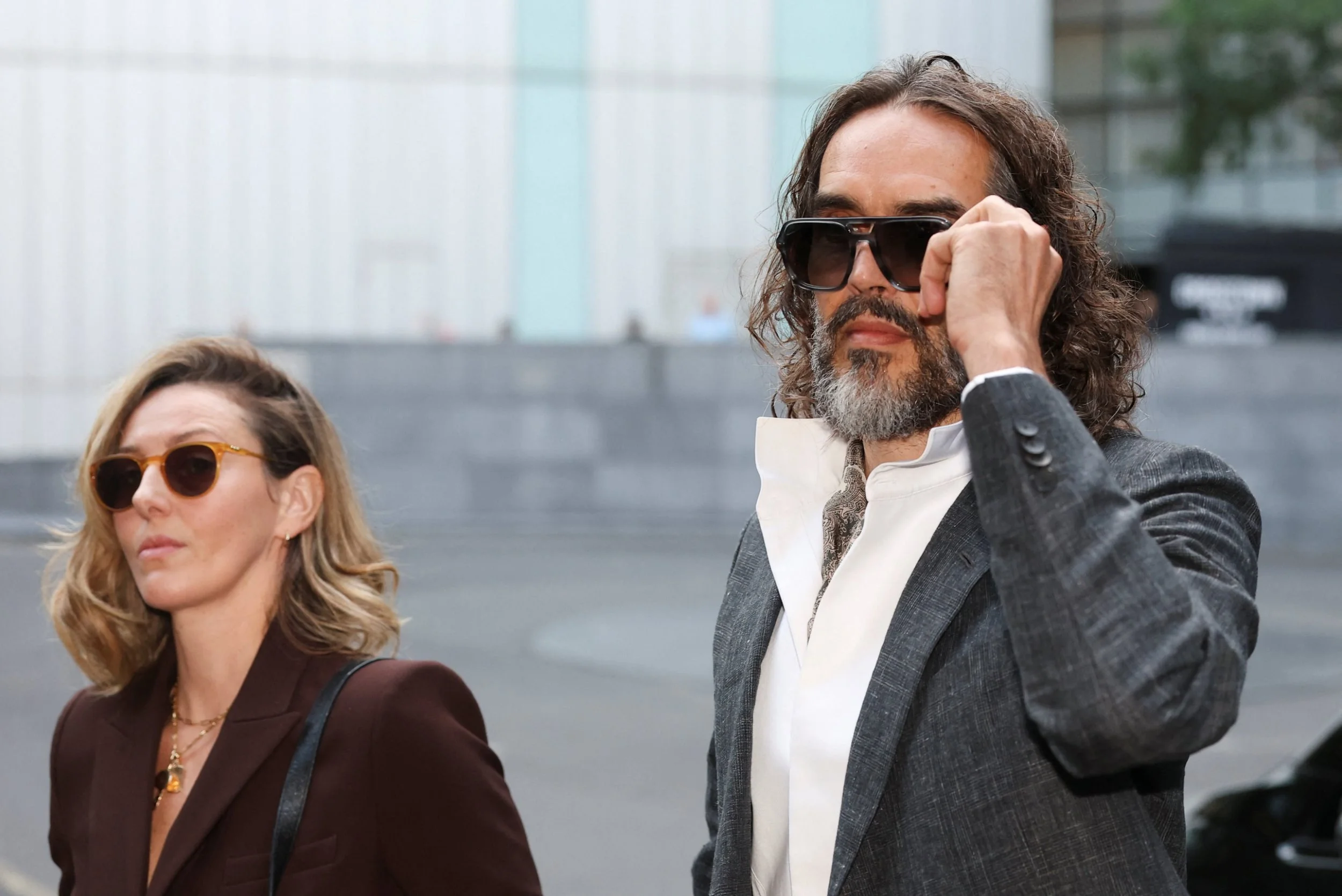 British actor and comedian Russell Brand and his wife Laura Brand arrive at Southwark Crown Court, where he is due to stand trial on charges of rape and sexual assault relating to six women, which he denies, in London, Britain, October 12, 2026. REUTERS/Toby Melville