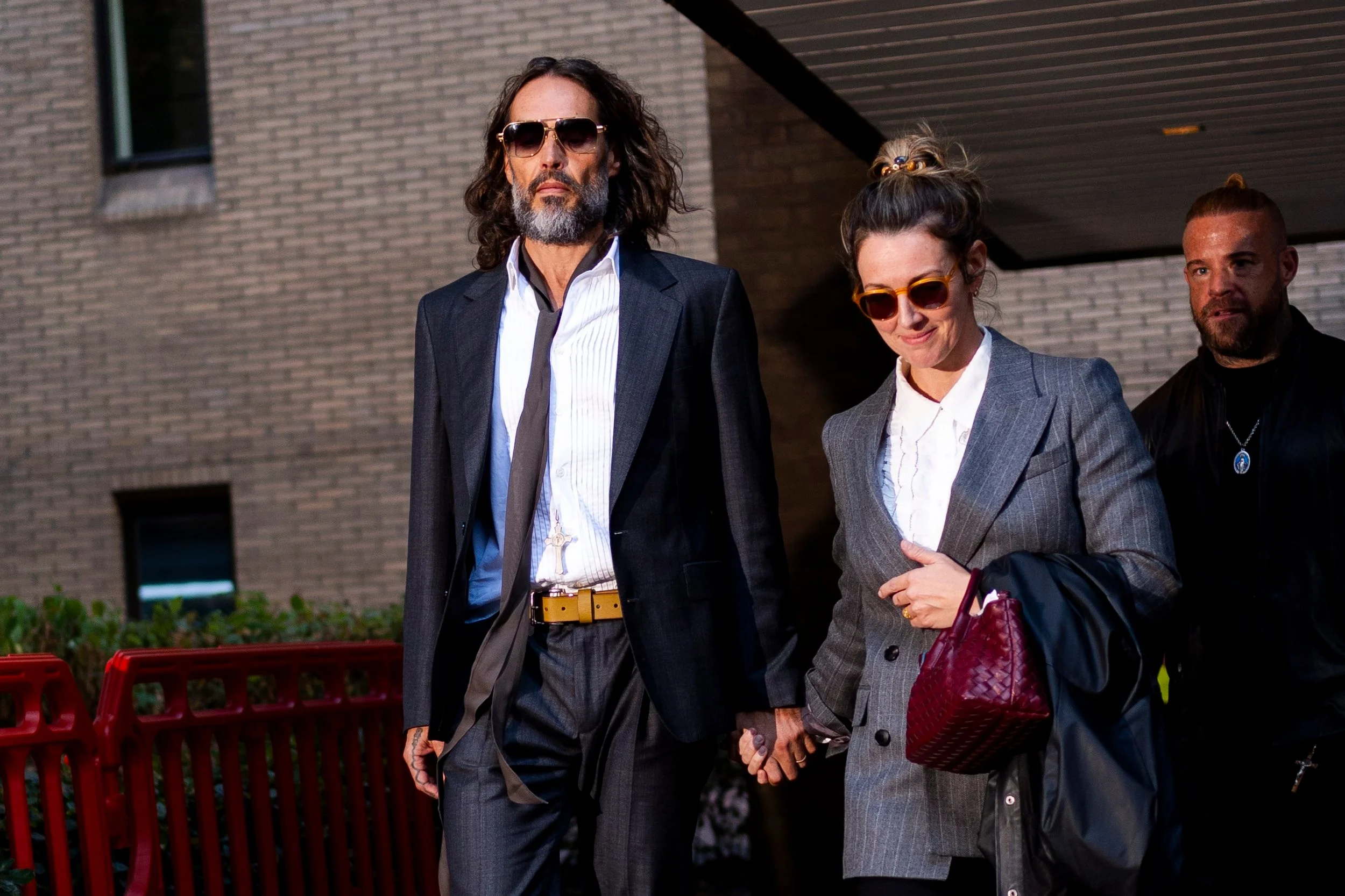 Russell Brand, accompanied by his wife Laura Gallacher, leaving Southwark Crown Court, London, where he faces three charges of rape, indecent assault, and three counts of sexual assault, relating to six women. Picture date: Friday October 16, 2026. PA Photo. Photo credit should read: Jordan Pettitt/the Press Association
